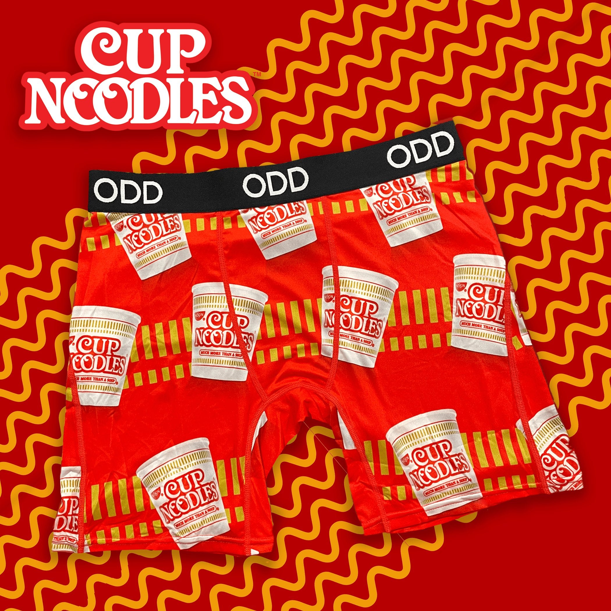 Red boxer briefs with a Cup Noodles print on a wavy red and yellow background, featuring the Cup Noodles logo.