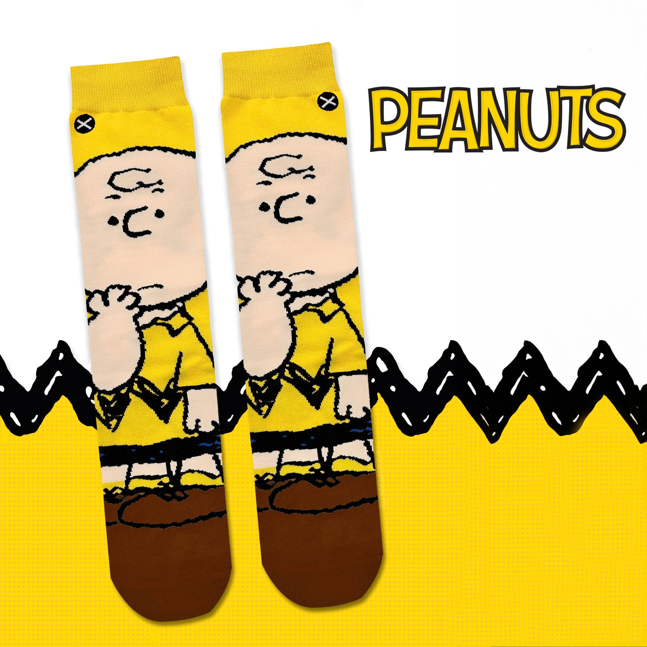 Yellow and black background with a zigzag pattern inspired by Charlie Brown’s shirt, featuring socks with a thoughtful Charlie Brown design, representing the classic Peanuts comic strip.