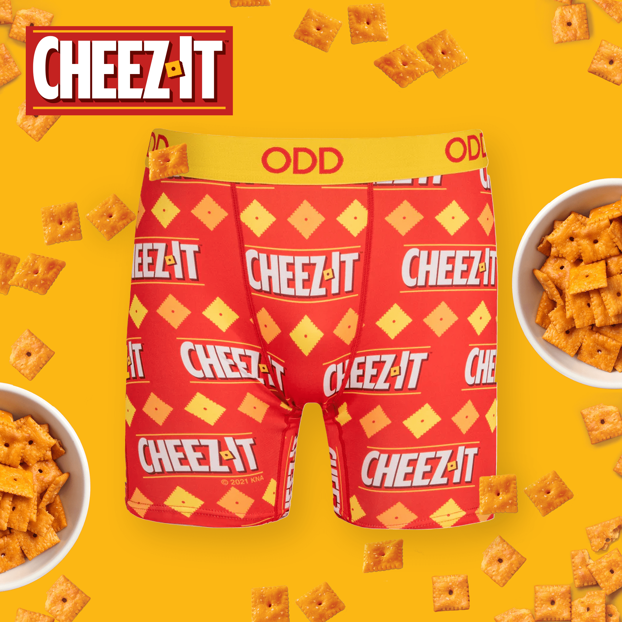 Bright yellow background with Cheez-It underwear and scattered crackers, representing the classic cheesy snack with a playful and appetizing theme.
