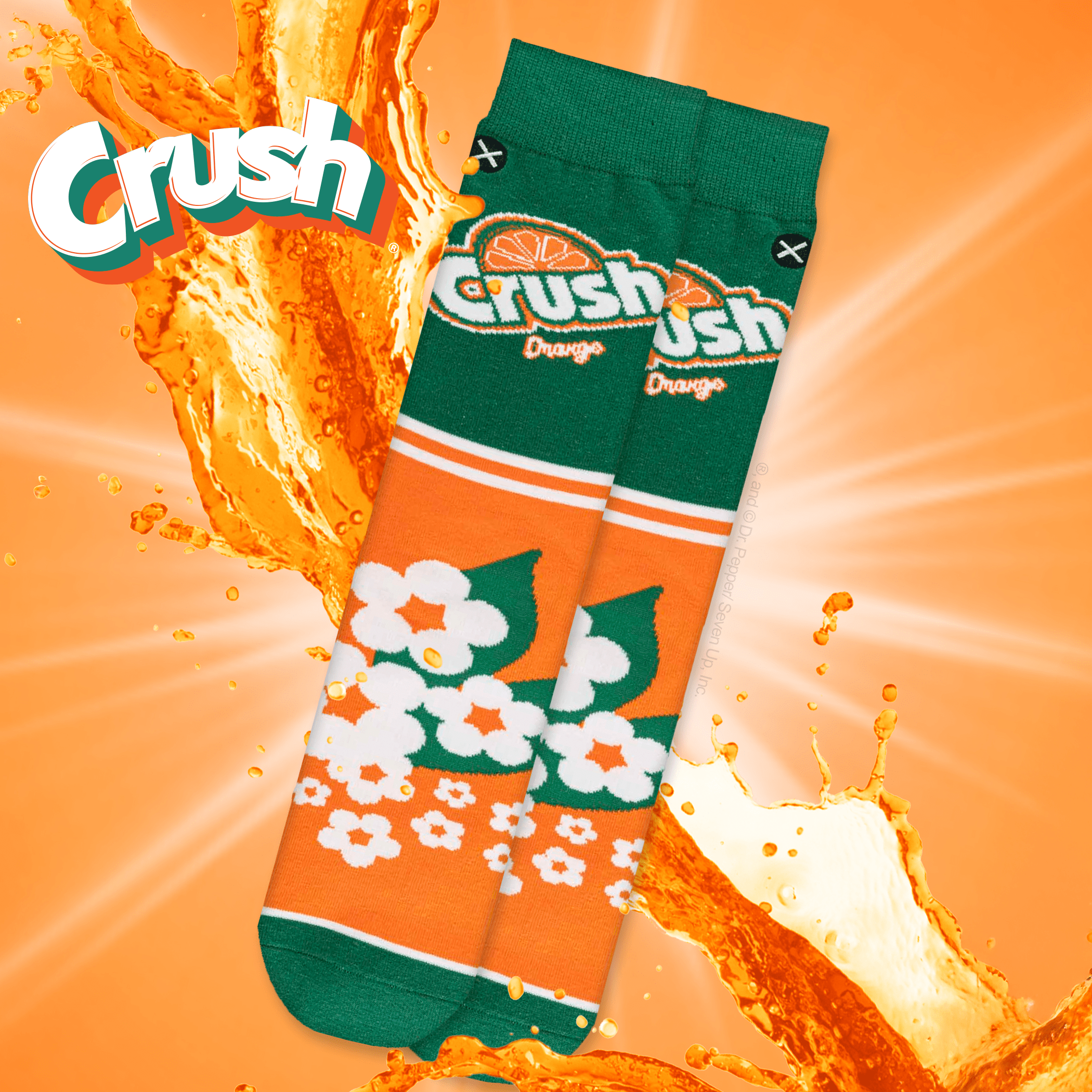 Vivid orange background with Crush Orange socks featuring a retro floral design, evoking a refreshing, citrusy energy with splashes of orange soda.