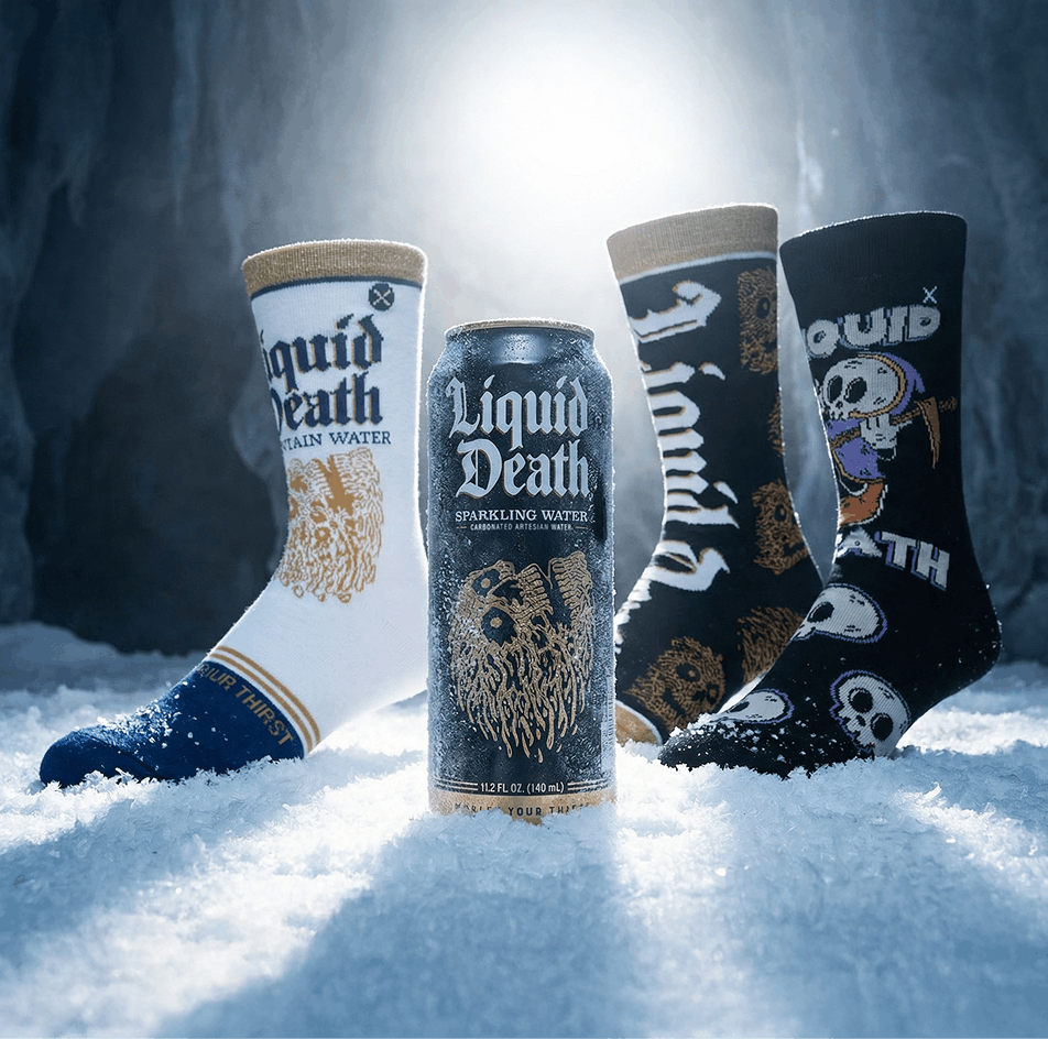 Cans and socks with 'Liquid Death' branding in a snowy setting