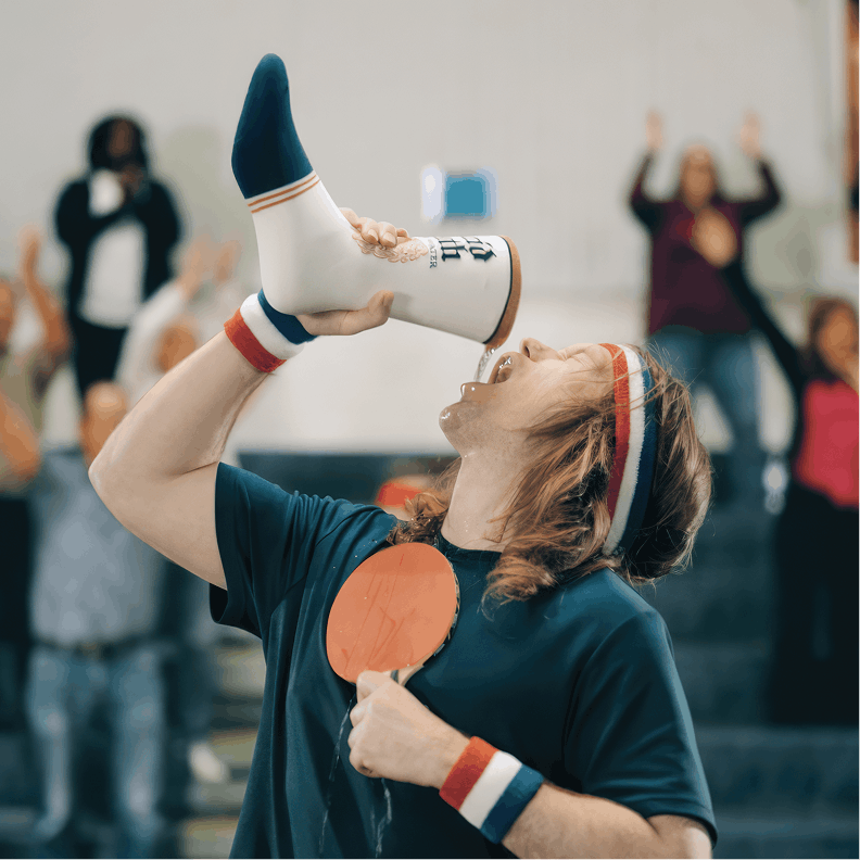Person holding a megaphone with a blurred crowd in the background