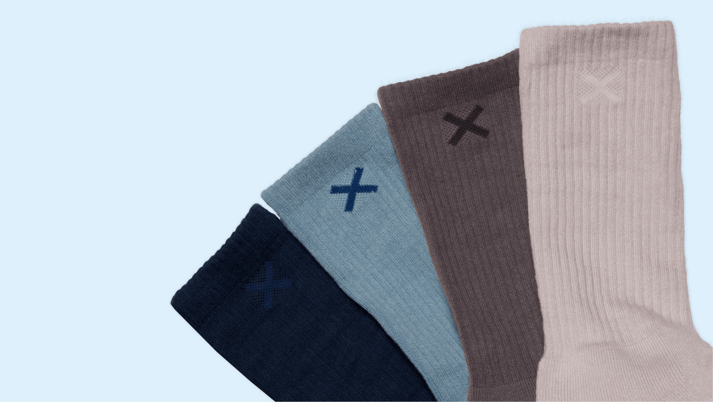 Four pairs of socks in different colors with 'X' designs on a light blue background