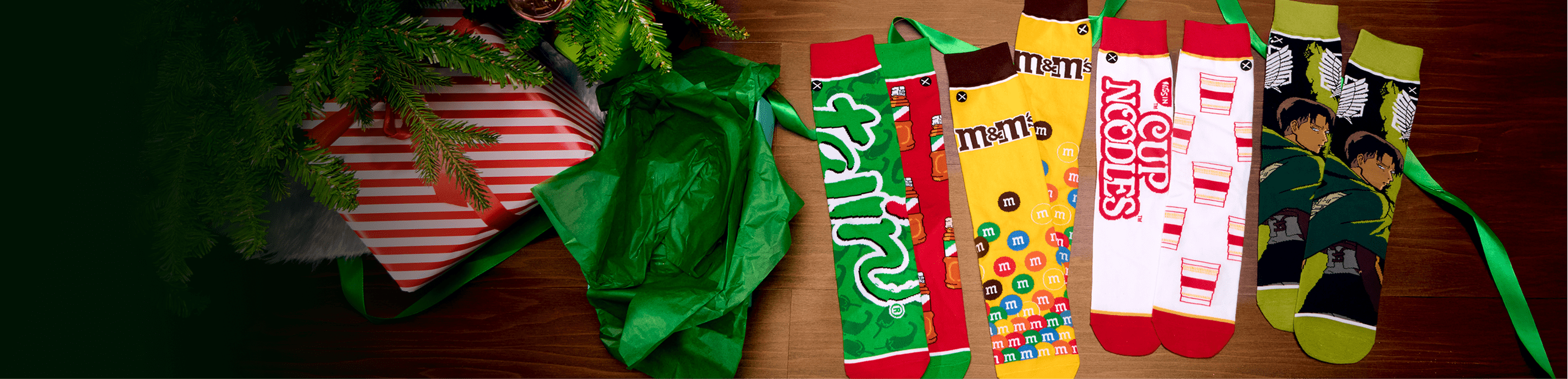 Collection of colorful socks with various designs on a wooden surface.