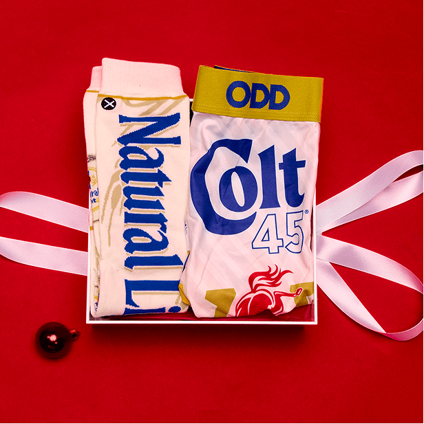 Two pairs of socks with 'Naturally' and 'Odd Colt 45' branding on a red background.