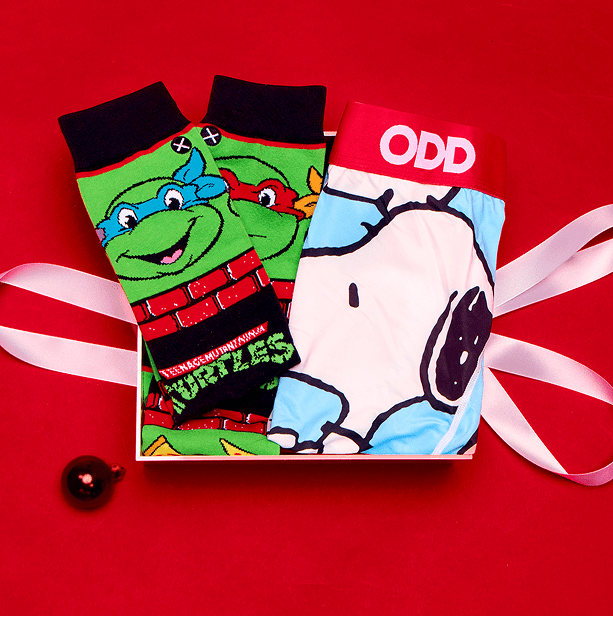 Two pairs of socks, one with a cartoon character and the other with a dog design, on a red background.