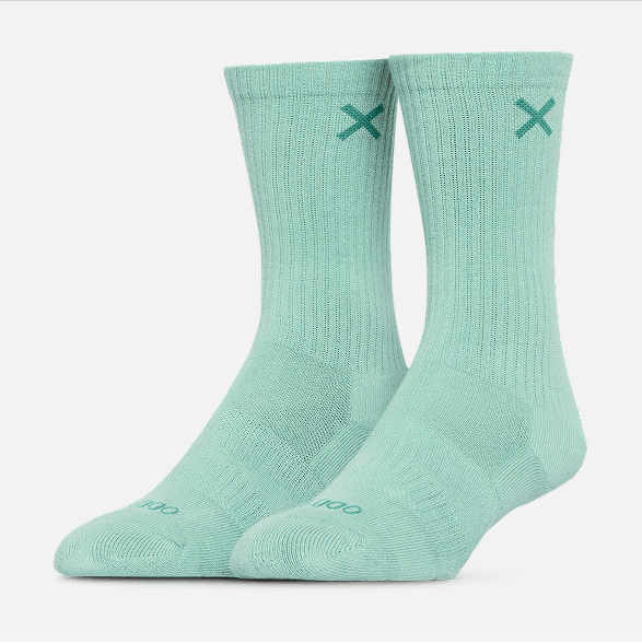 Pair of light green socks with a logo on a white background