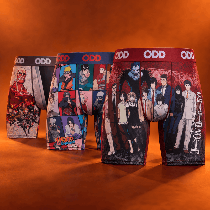 Three pairs of graphic boxer briefs displayed upright on a warm orange studio background. The underwear features anime and manga character prints, with the waistbands branded 'ODD'.