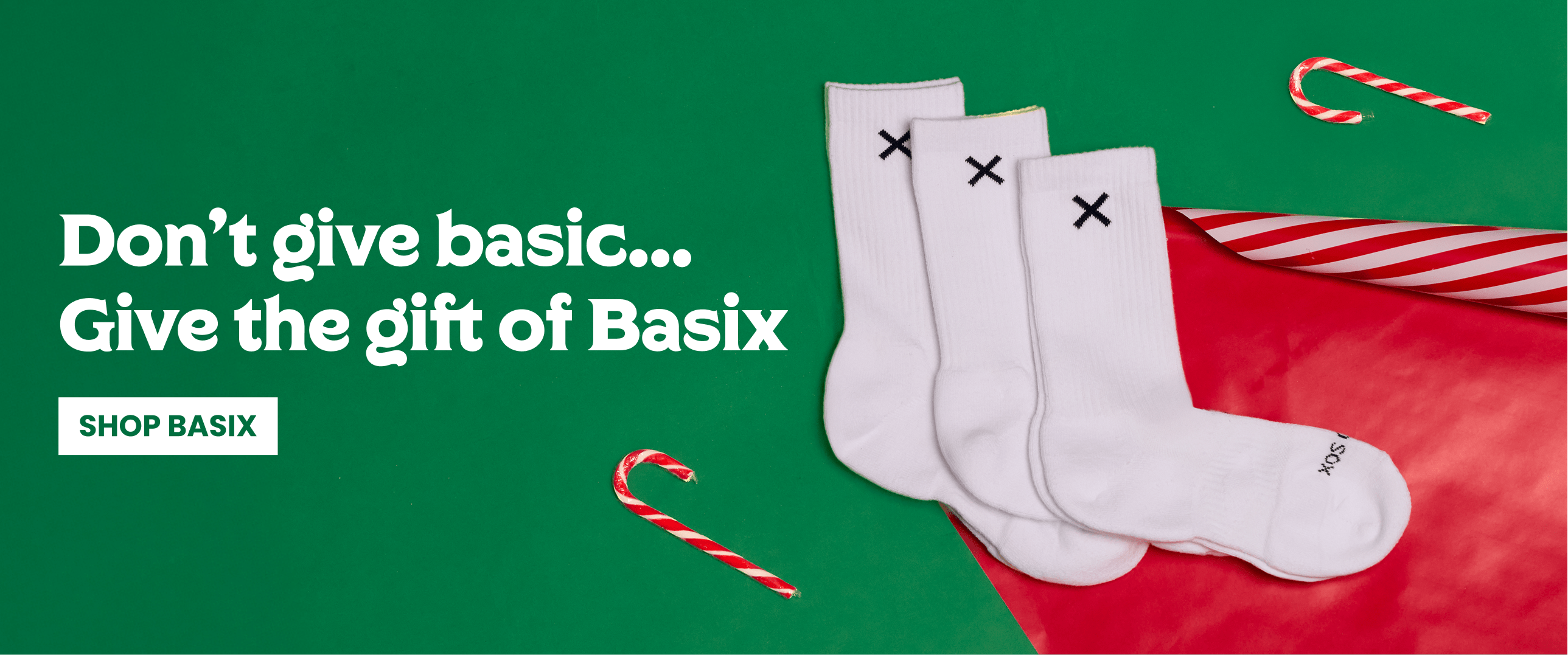 White socks with black X marks on a green and red background with candy canes.