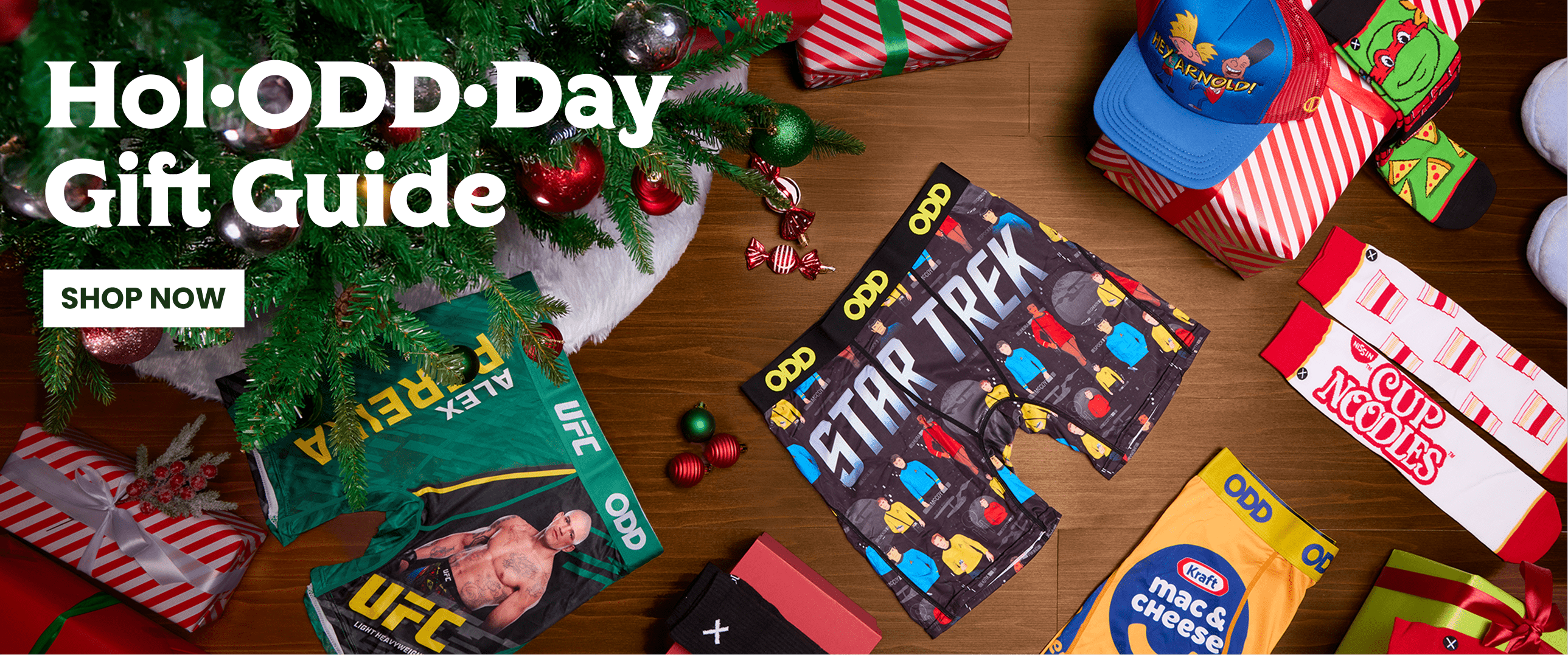 Gift guide with various themed gift boxes on a wooden surface, including 'Star Trek' and 'UFC' boxes.