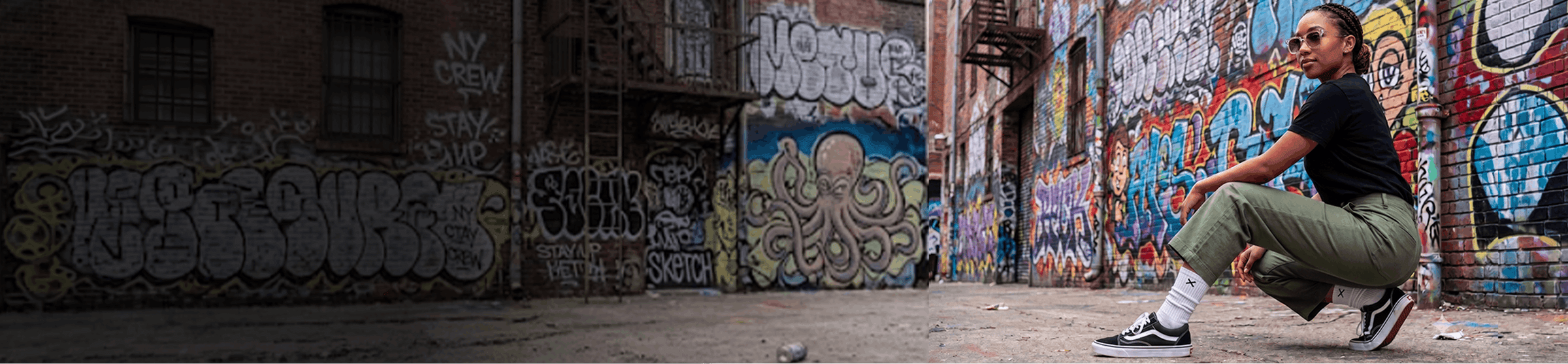 Person squatting in an alley with graffiti-covered walls