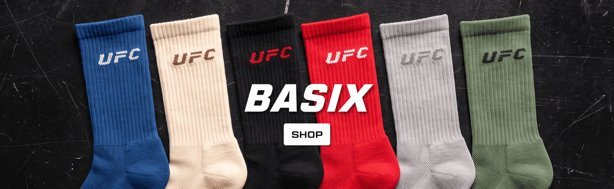 Six pairs of ribbed UFC socks in blue, beige, black, red, gray, and olive green are lined up side-by-side on a dark textured background with a central 'BASIX SHOP' graphic overlay.