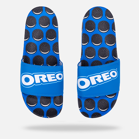 Blue sandals with black circular patterns and 'OREO' branding on a white background