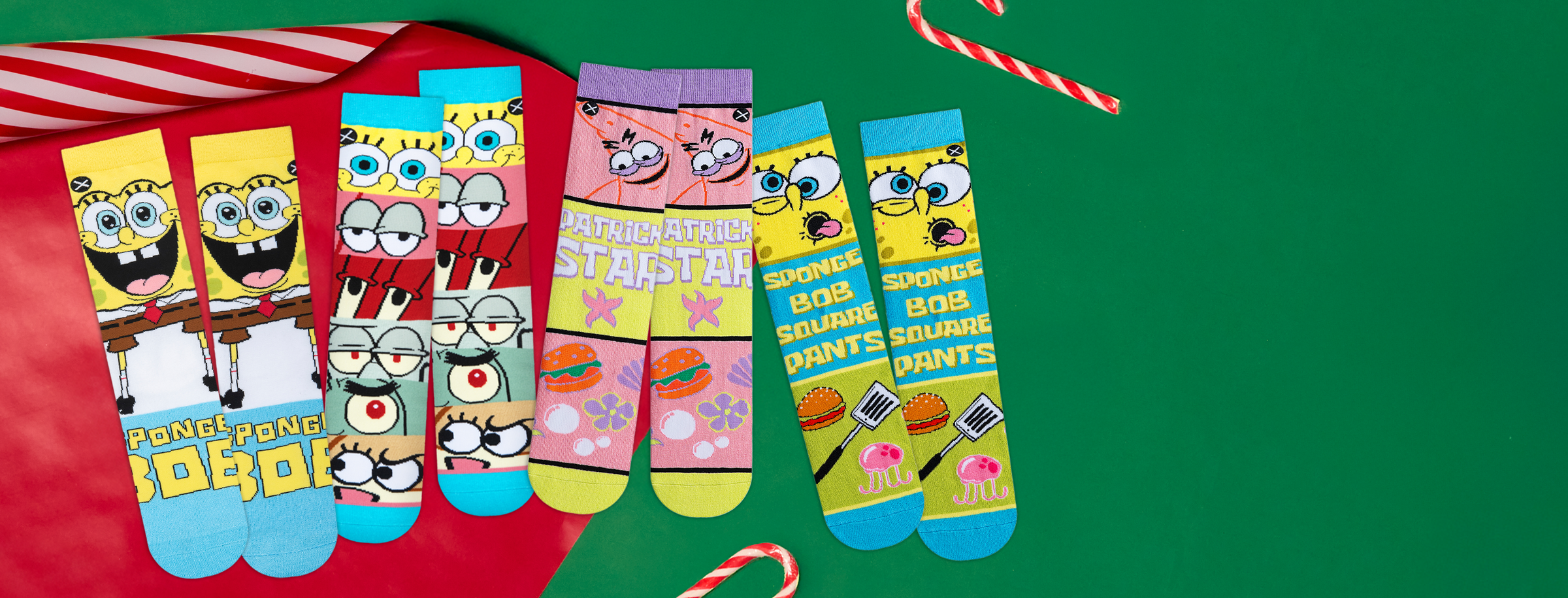 Colorful socks with cartoon characters on a green background